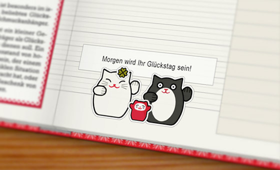 Foto vom Lily Lux Notizbuch mit Winkekatzen Aufklebern und einem Glückskekszettel – Morgen wird Ihr Glückstag sein!